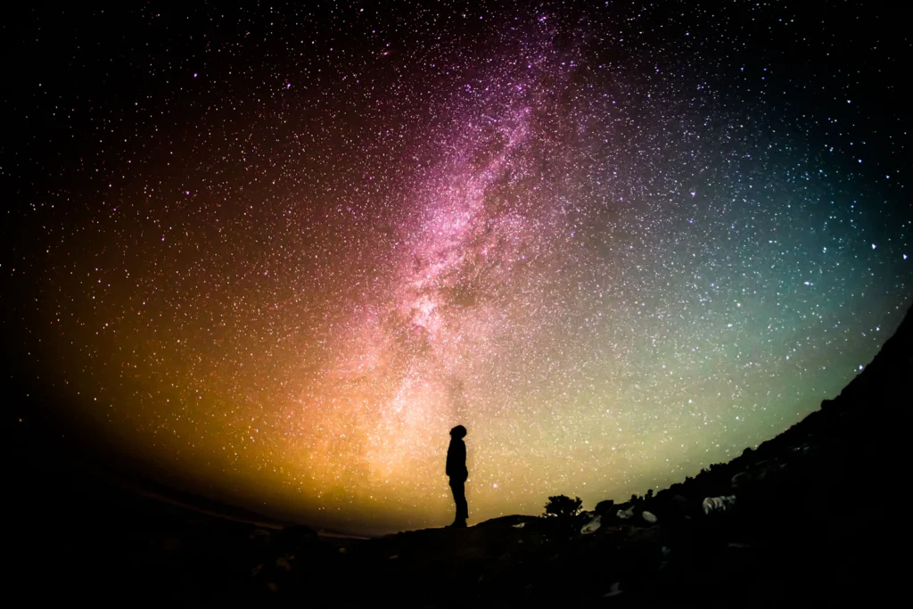 Silhouette of a person beneath a star-filled night sky, a visual prompt for a birth chart reading